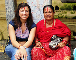 A younger woman sits next to an older woman in Nepal. 