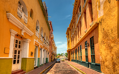 A street in Cartegna, Colombia lined with yellow houses. 