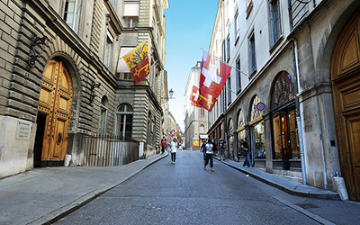Shopping street in Geneva with flags hanging on either side