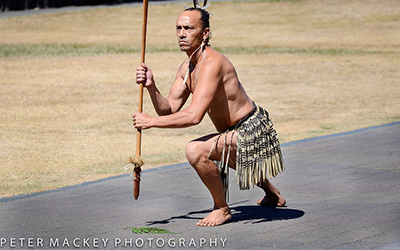 Maui man poses on road in traditional clothing