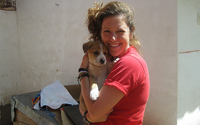 Volunteer holding puppy in Peru