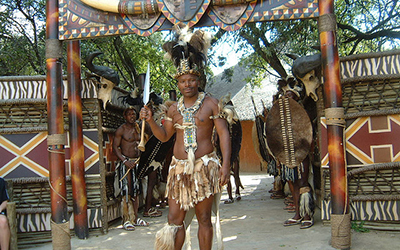 Male Zulu dancer stands outside Village near Johannesburg, South Africa