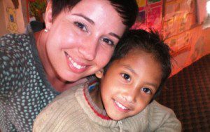 Volunteer with a child at the counseling center in Nepal