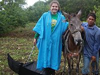 volunteer poses with donkey in costa rica