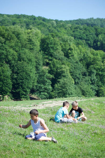 green mountain with children playing